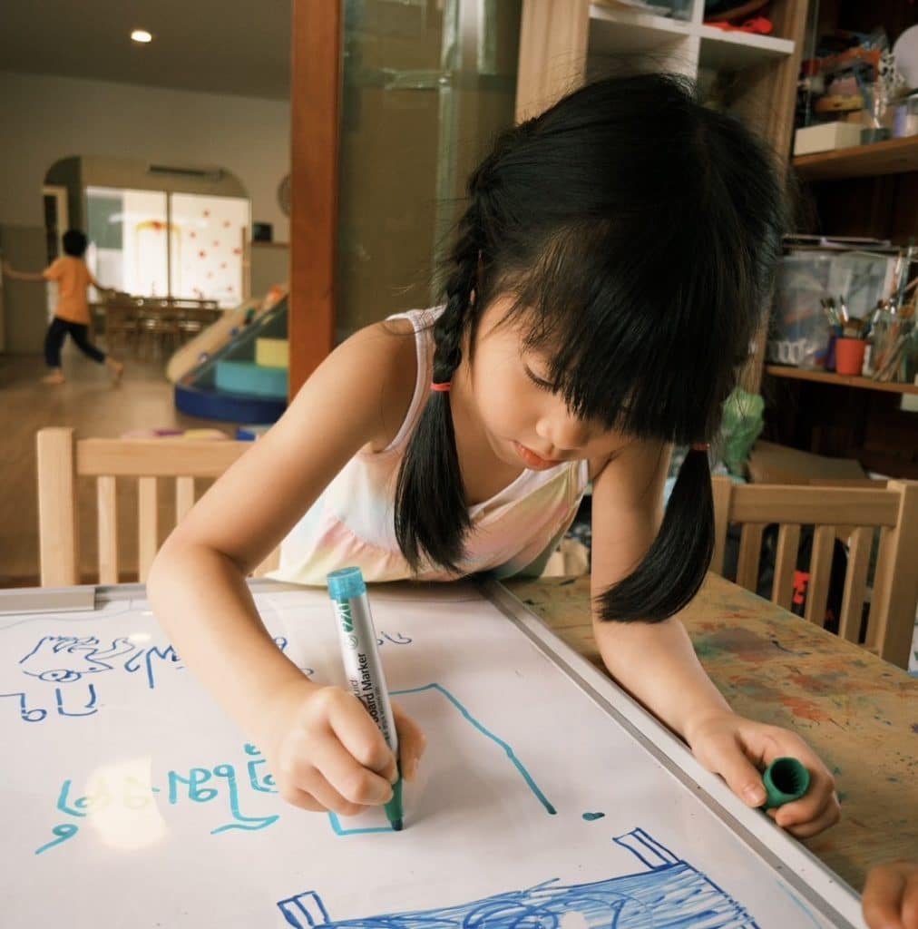 Children singing in English and Thai during a playgroup at Firefly Forest School’s alternative school in Thailand.