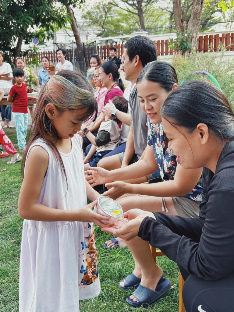 A family enjoying a campfire night at Firefly Forest School’s family-friendly summer camp in Bangkok.

