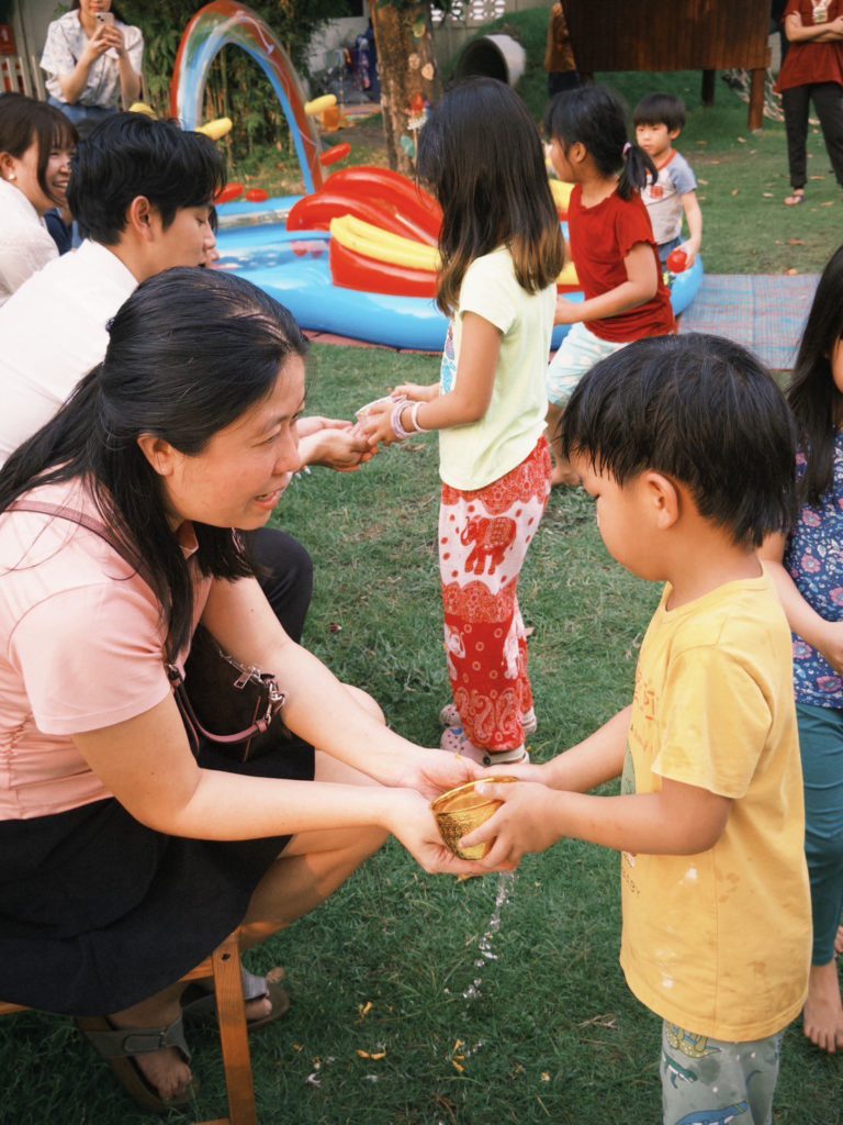 A family enjoying a campfire night at Firefly Forest School’s family event in Bangkok.

