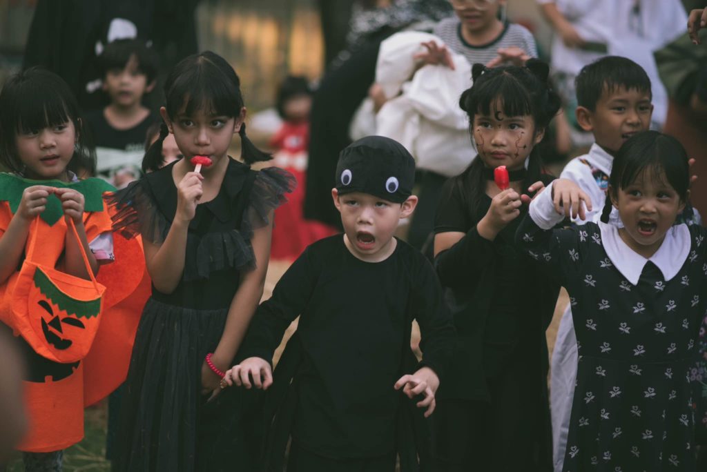 "Children performing a play under the trees during a creative drama class at Firefly Forest School in Bangkok."