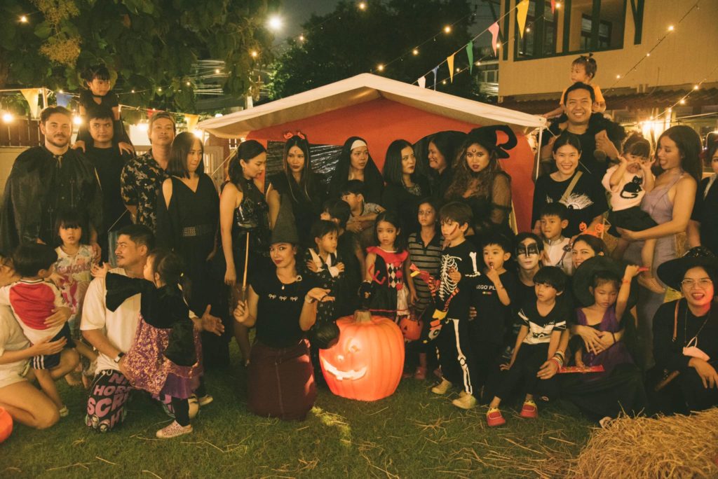 A family enjoying a campfire night at Firefly Forest School’s family event in Bangkok.

