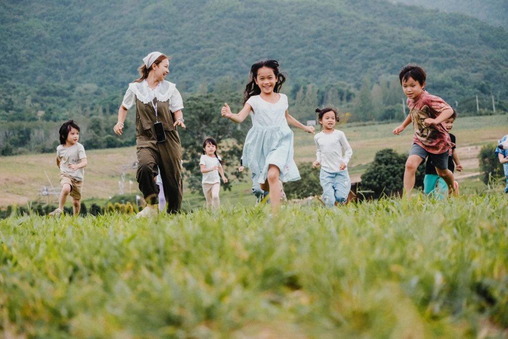 Children playing outdoors at Firefly Forest School’s preschool, a top choice in Bangkok.

