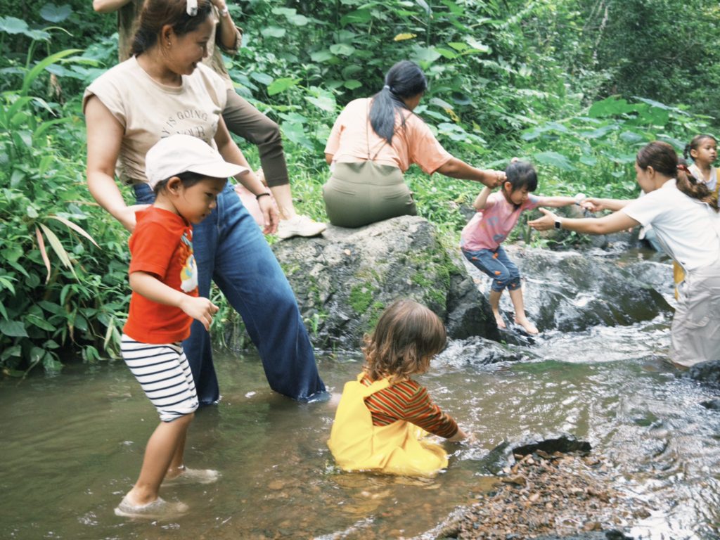 Preschoolers exploring sensory play in the Secret Garden at Firefly Forest School in Bangkok

