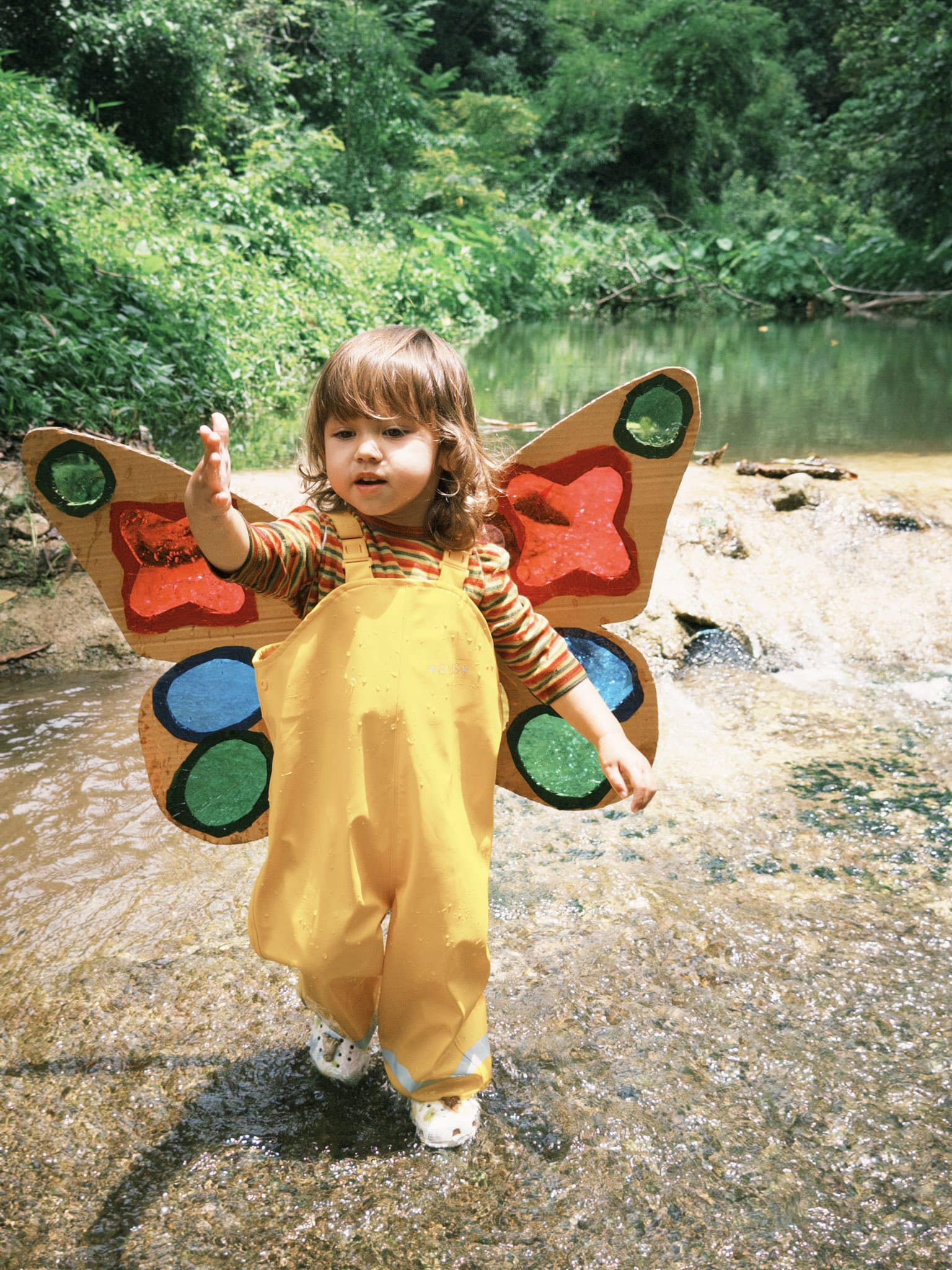A child building a fairy house during a child-led learning session at Firefly Forest School in Bangkok.