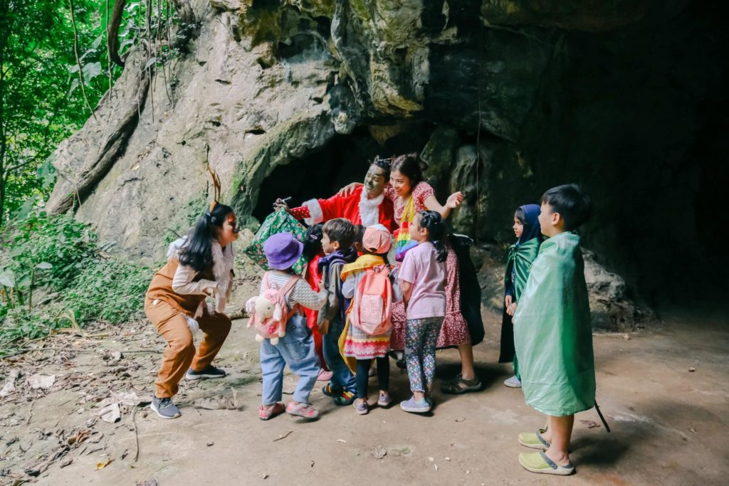 Children exploring a cave during a summer camp at Kaeng Krachan National Park with Firefly Forest School.

