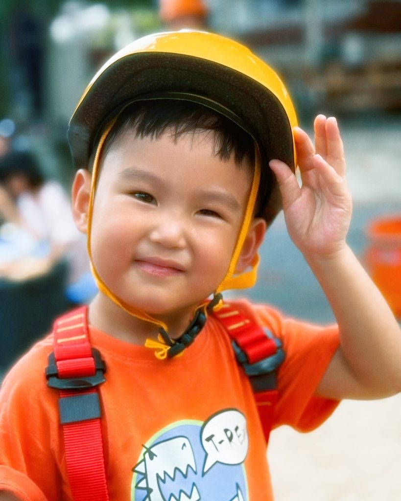 "Toddlers splashing in puddles during a nature camp at Firefly Forest School in Bangkok."

