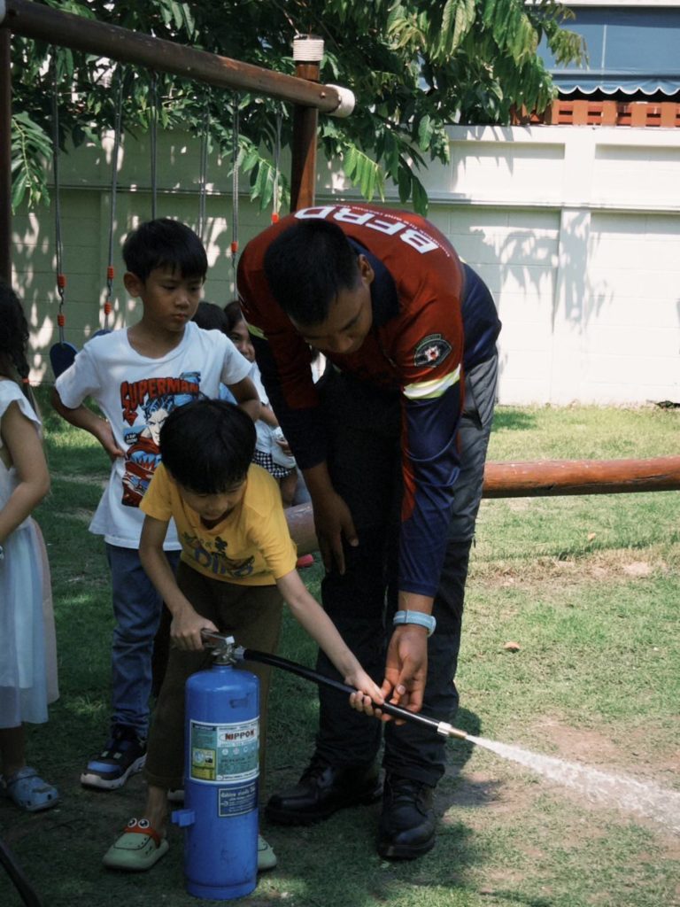 A group of kids learning how to survive the emergency event under the trees at Firefly Forest School’s Waldorf-inspired school in Bangkok.

