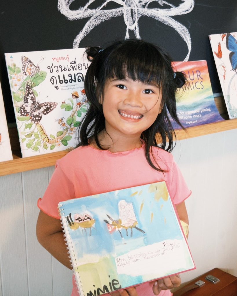 A child painting with natural dyes during a holistic education activity at Firefly Forest School’s preschool in Bangkok

