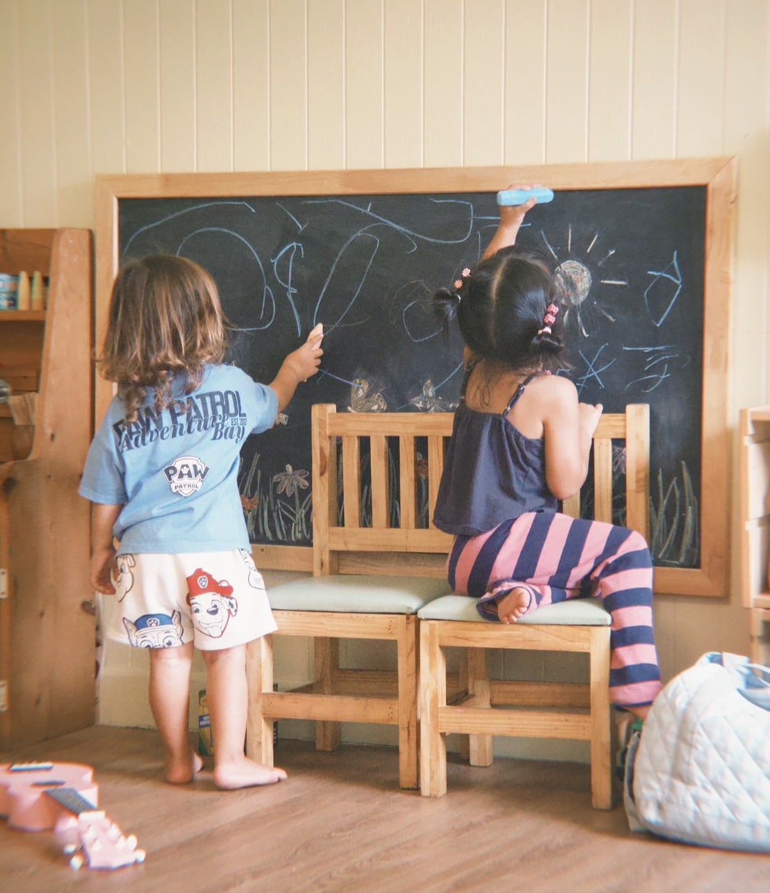 Toddlers exploring sensory play in the Secret Garden at Firefly Forest School’s Montessori-inspired school in Bangkok.