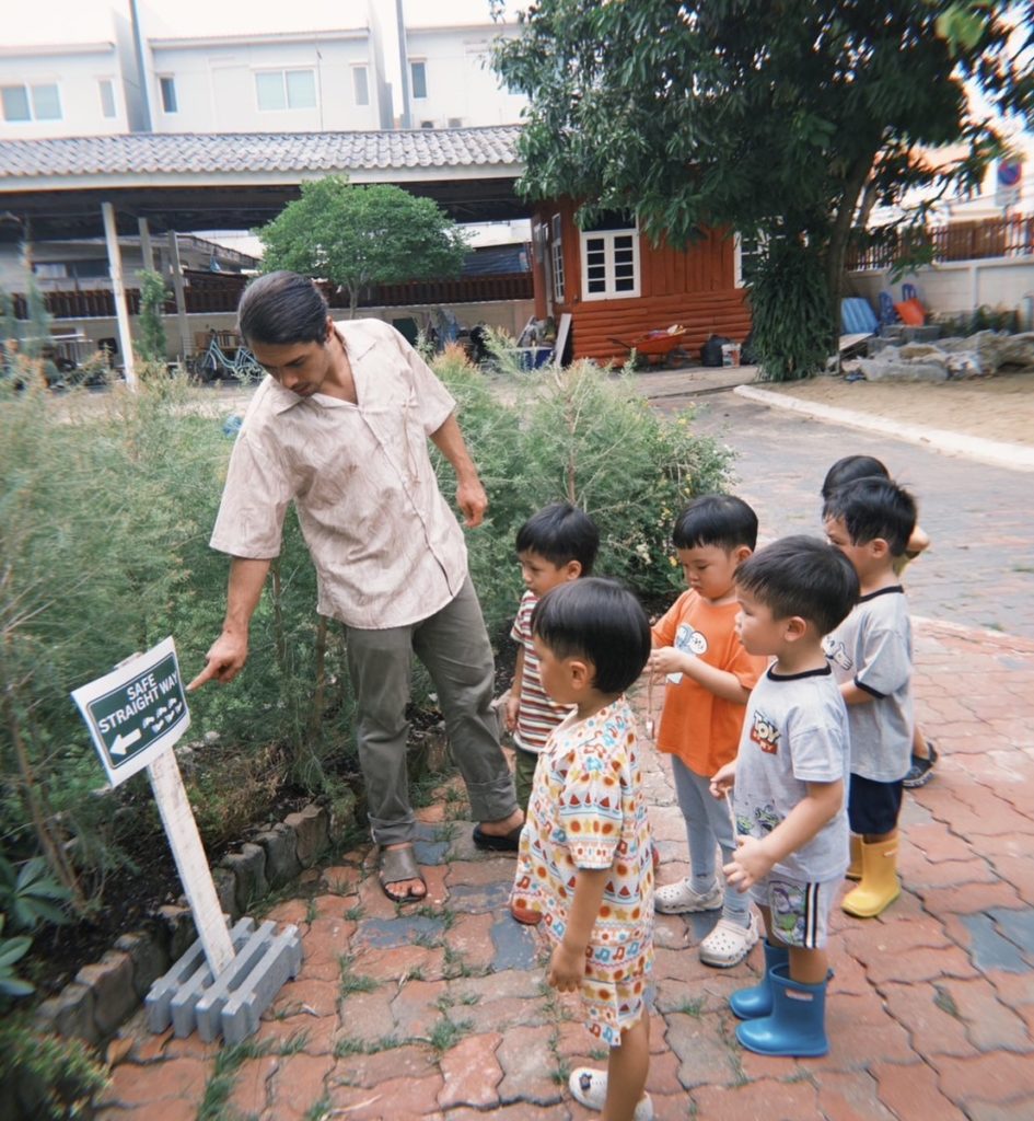 A toddler exploring the Secret Garden at Firefly Forest School’s alternative school in Bangkok.


